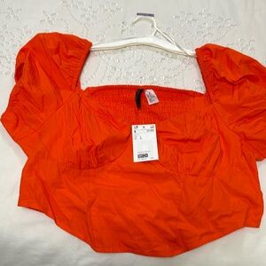 H&M orange crop top with puff sleeves.